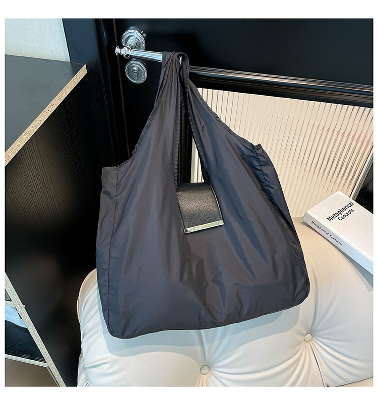 Black lightweight foldable tote hanging indoors